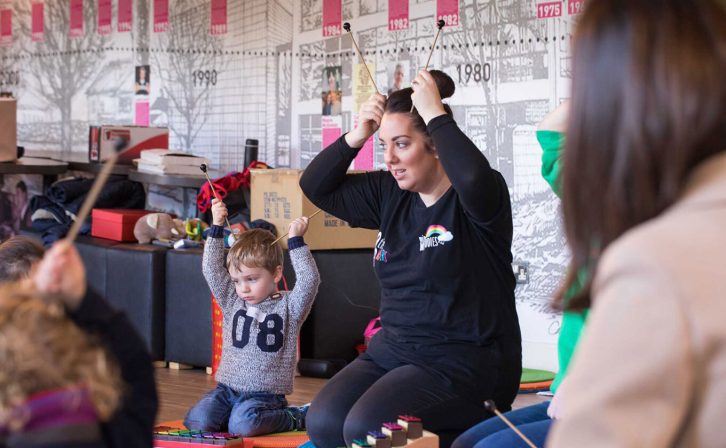A woman and a child taking part in a playful workshop in the foyer of the theatre