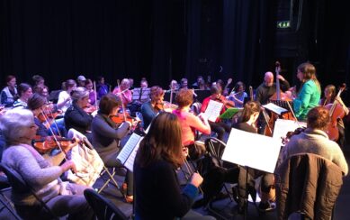 A photograph depicting the Sligo Adult Community Orchestra in rehearsal