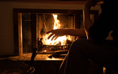 Man warming his hands by a fire 