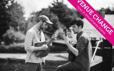 Black and white photo of two young men playing mandolins