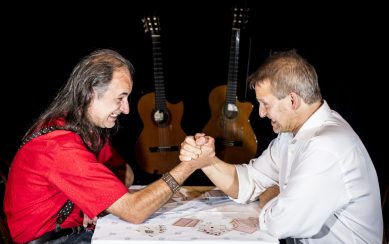 Two men are arm-wrestling. 