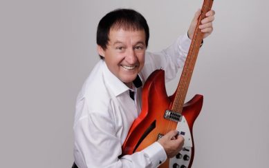 Performer Declan Nerney posing with a guitar 