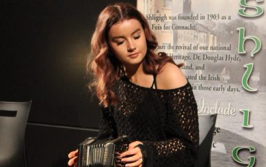 Girl sitting playing concertina