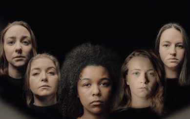 A photograph of five women's faces against a black background