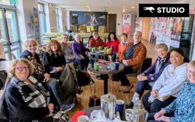 A group of people sitting and smiling for a photograph