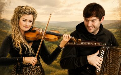 Girl playing violin next to guy playing accordian