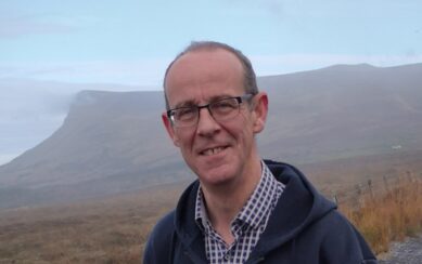 Photo of man with mountain in the background 