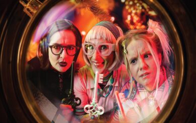 Two grannies and a girl looking at a key 