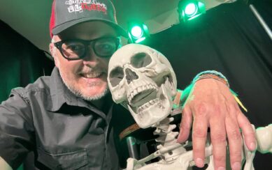 man with his arm around a skeleton 
