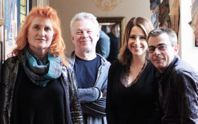 Four people smiling for the camera