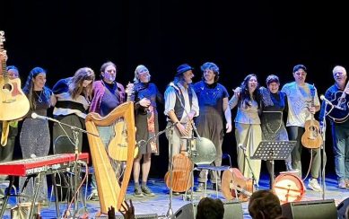 A photograph of the Folk Families performers on stage
