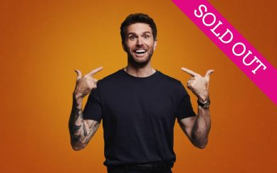 Joel Dommett smiles at the camera