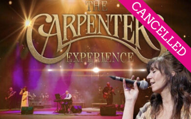 The background is an image of the band performing. On the right there is a woman singing and facing the left. In front of that is large gold text which reads "The Carpenters Experience"