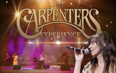 The background is an image of the band performing. On the right there is a woman singing and facing the left. In front of that is large gold text which reads "The Carpenters Experience"