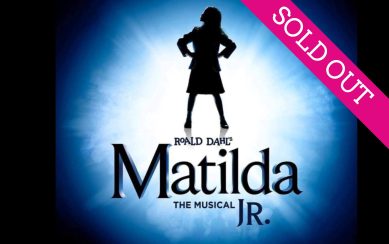 A silhouette of a girl at the centre of a blue burst