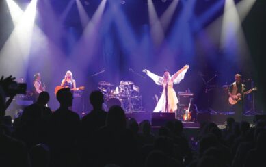 Singers are on stage performing in front of an audience
