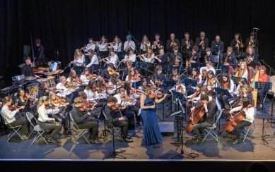 A photograph of the Sligo Academy of Music orchestra performing on stage