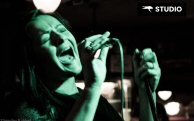 Woman singing into a microphone