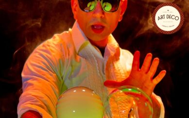 Performer wearing sunglasses creating bubbles