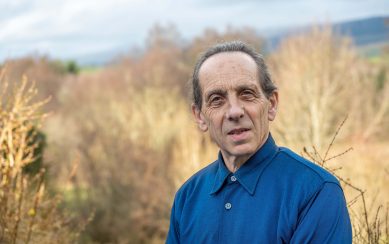 Photo of man in a field wearing a blue shirt Photo of man in a field wearing a blue shirt