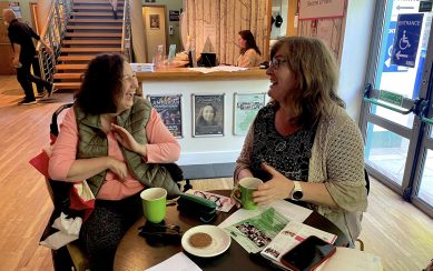 An image of theatre patrons laughing over a cup of tea An image of theatre patrons laughing over a cup of tea
