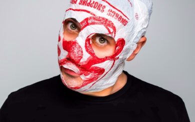 close head shot of man whose face is wrapped in a plastic bag