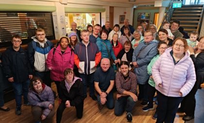 A photograph of the participants and tutors from the SHINE programme taken in the Hawk's Well Theatre foyer.