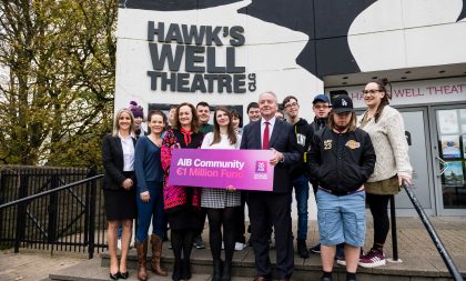 A photograph of Hawk's Well staff with AIB representatives and attendees of the SHINE workshops. Two people at the front are holding a sign saying AIB Community €1 Million Fund A photograph of Hawk's Well staff with AIB representatives and attendees of the SHINE workshops. Two people at the front are holding a sign saying AIB Community €1 Million Fund