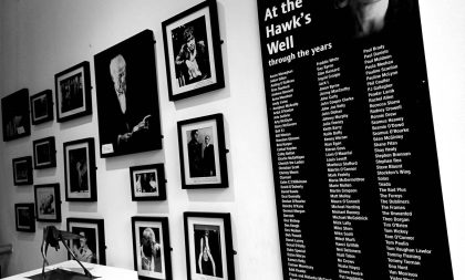 A wall decorated with images of the theaters history