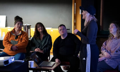 People sitting listening to a speaker 