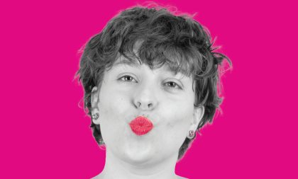 A black and white photograph of Katelyn Ressler blowing a kiss. The background and highlight of her lips are bright pink. A black and white photograph of Katelyn Ressler blowing a kiss. The background and highlight of her lips are bright pink.