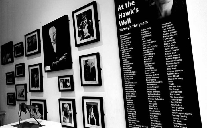 Framed photographs on the wall of artists who performed in the Hawk's Well over the last forty years. 