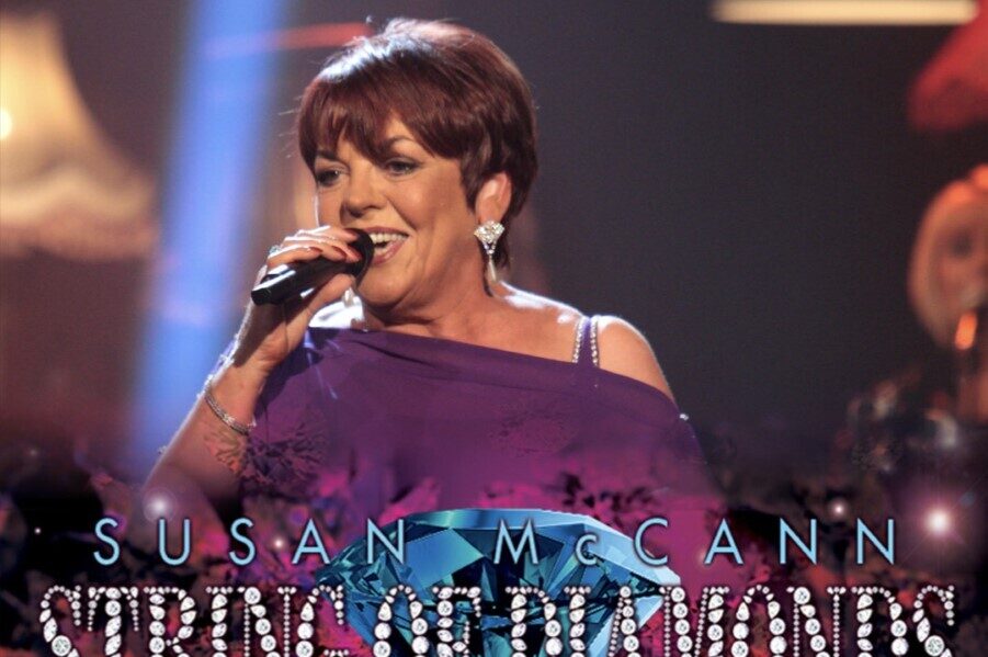 The poster for Susan McCann's tour, featuring Susan singing into a microphone and smiling. 