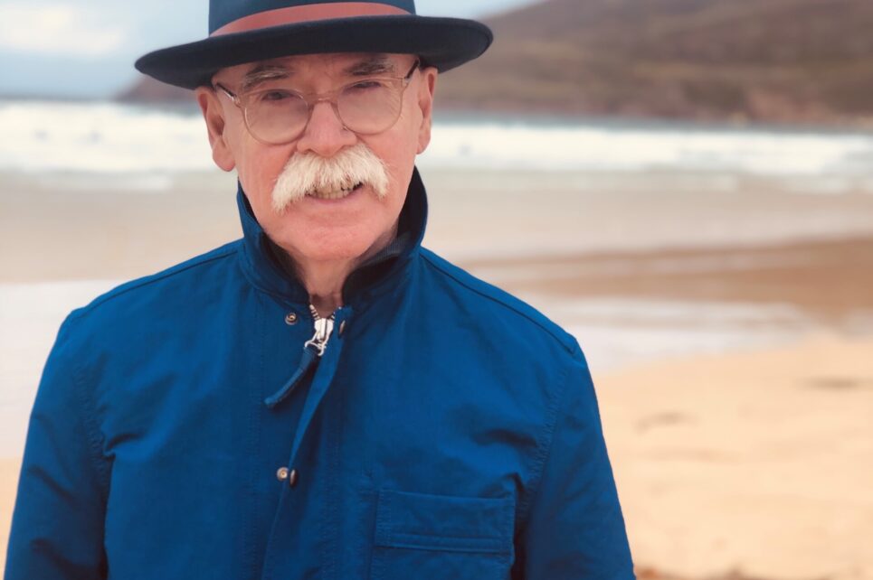 A portrait photograph of Paul Charles on a beach