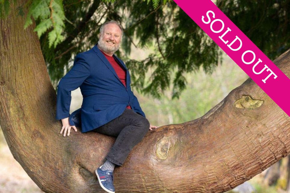 Comedian sitting on the branch of a tree