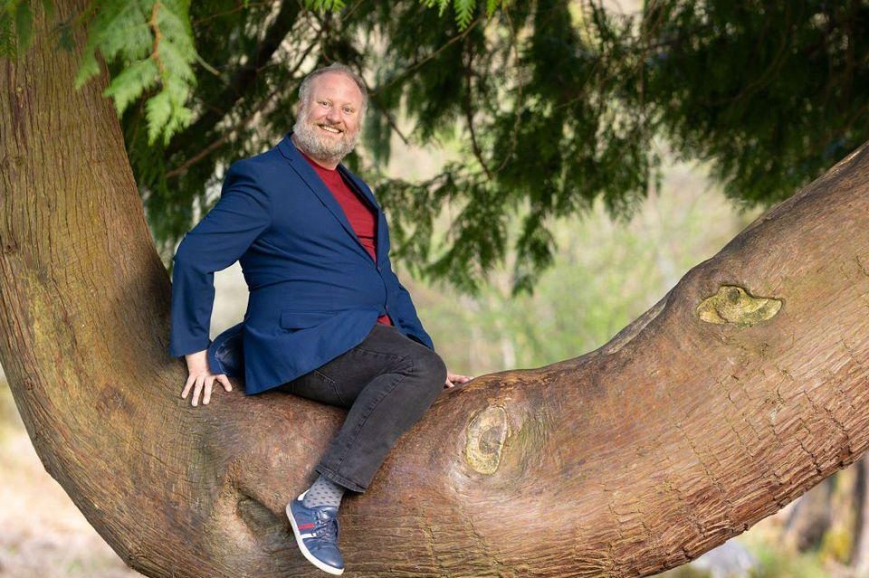 Comedian sitting on the branch of a tree Comedian sitting on the branch of a tree