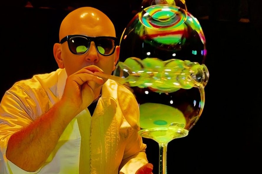 Performer wearing sunglasses creating bubbles