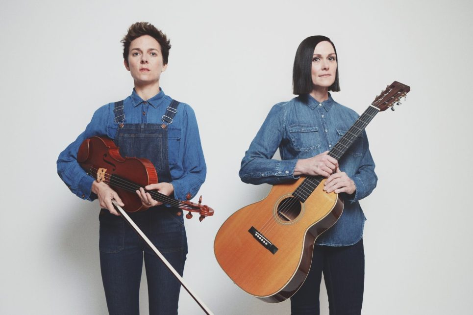 Beth Meyers and Monica Mugan posing with their instruments Beth Meyers and Monica Mugan posing with their instruments