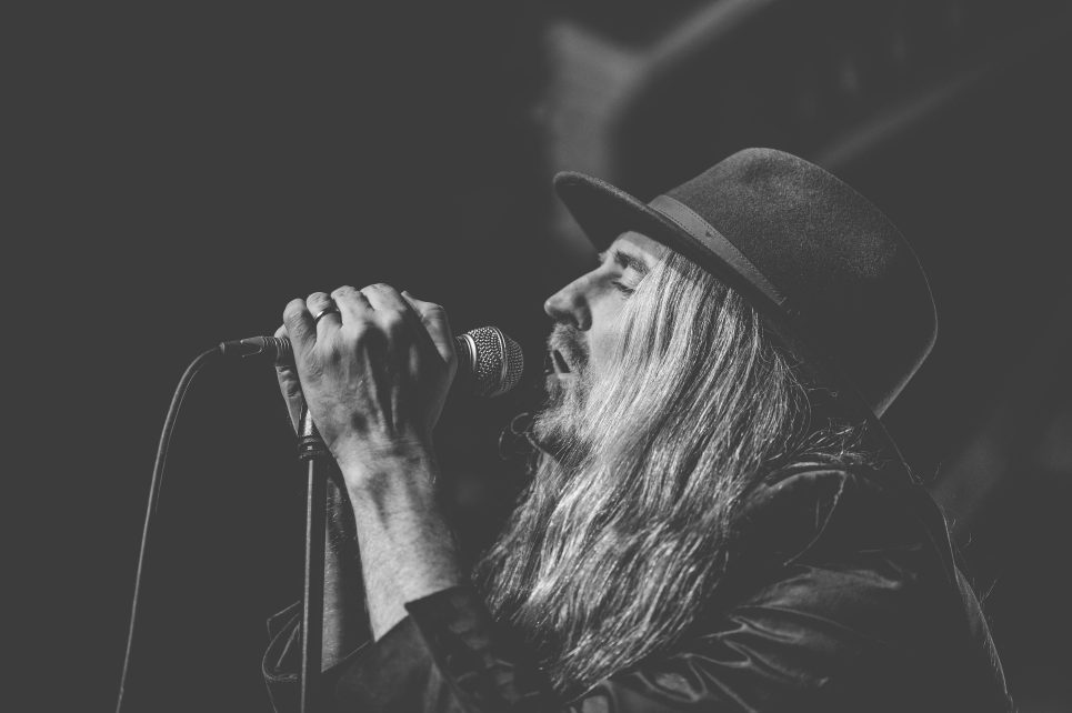 A black and white photo of Cormac Nesson singing A black and white photo of Cormac Nesson singing