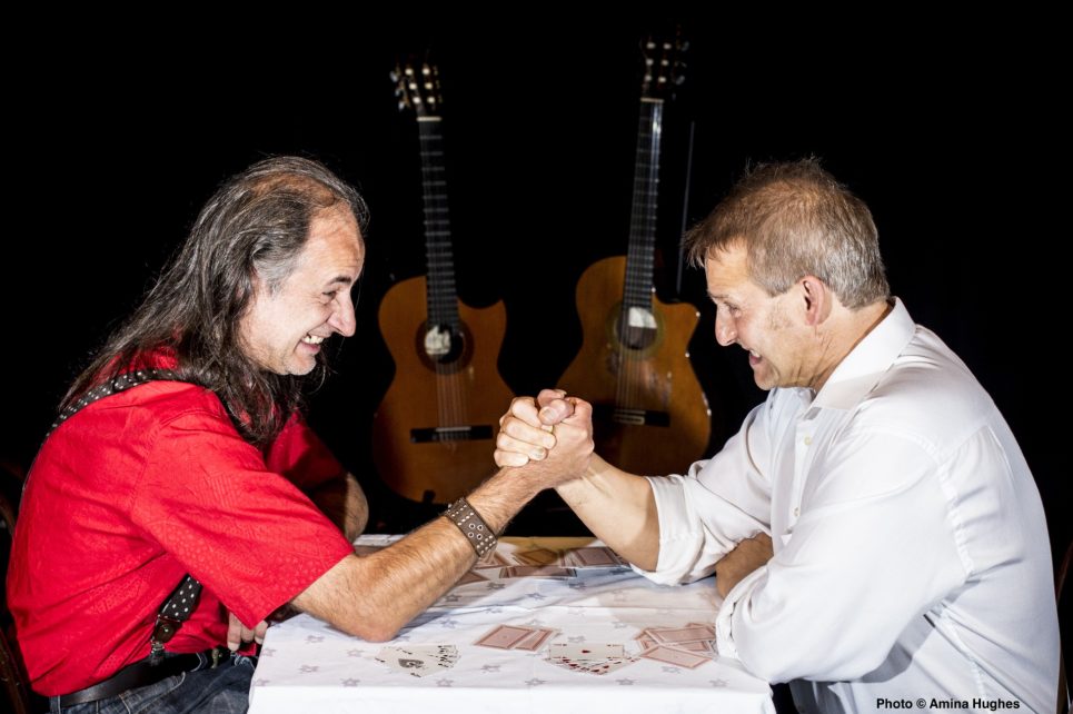 Two men are arm-wrestling. 