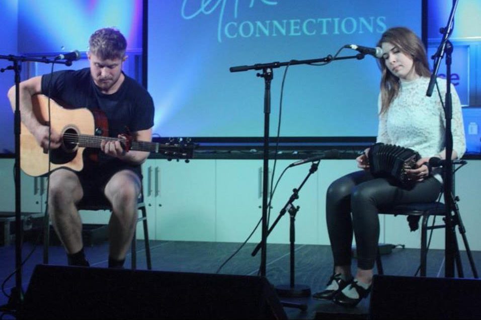 Boy playing guitar and girl playing concertina