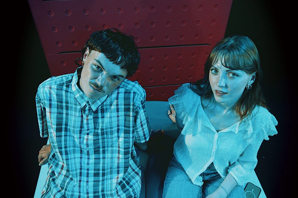 A photo of Molly Buchan and Callum Wall sitting on a couch