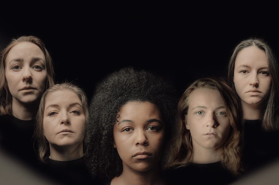 A photograph of five women's faces against a black background