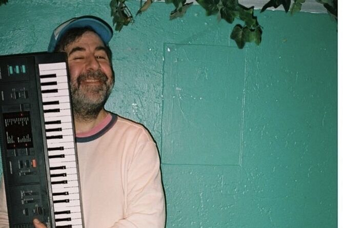 comedian holding a keyboard 