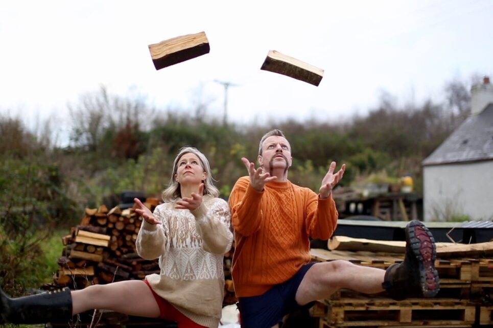 Man and woman juggling logs