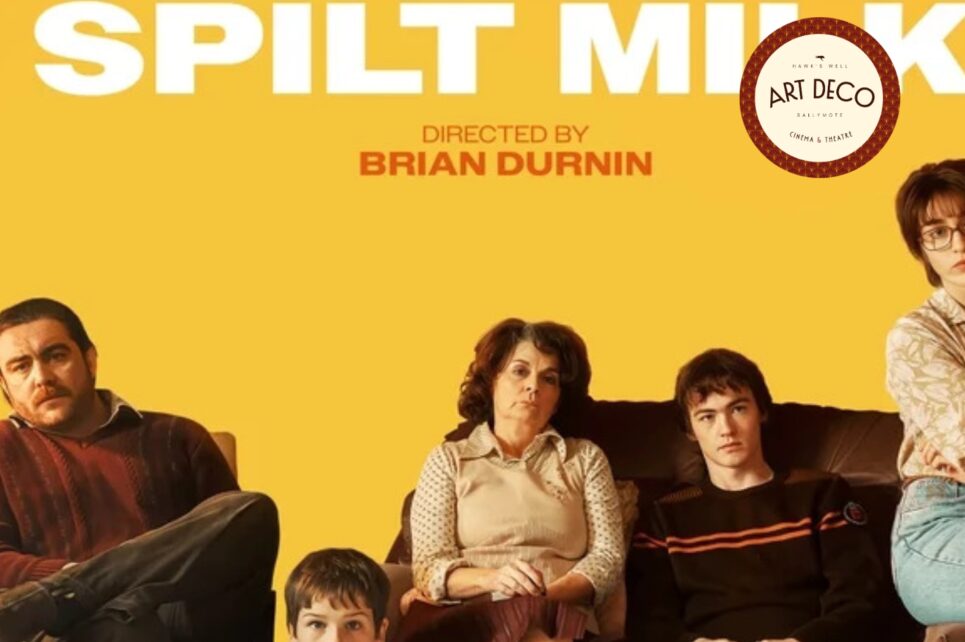 Family sitting against a yellow background