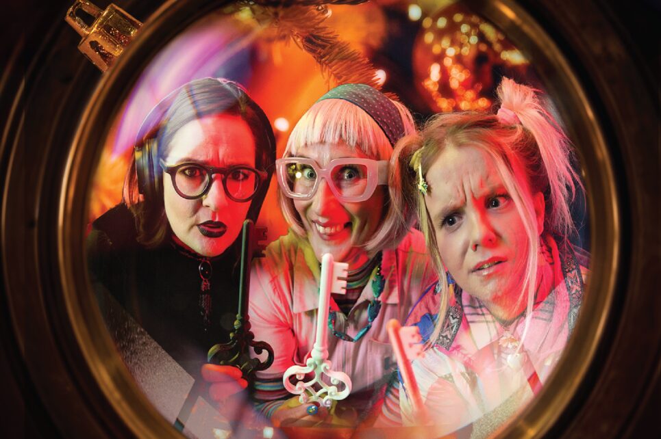 Two grannies and a girl looking at a key 