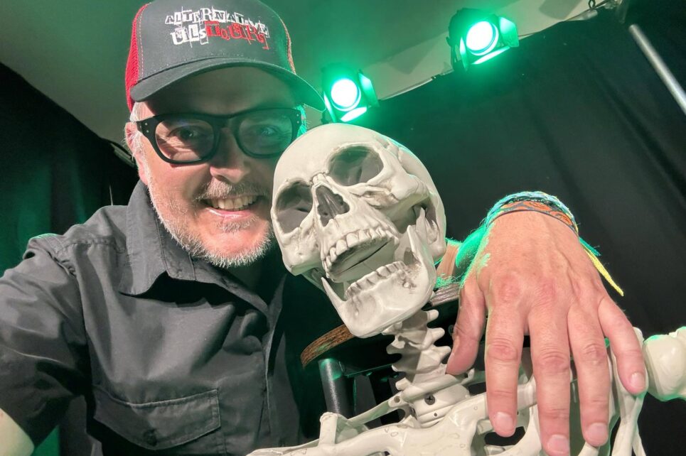 man with his arm around a skeleton