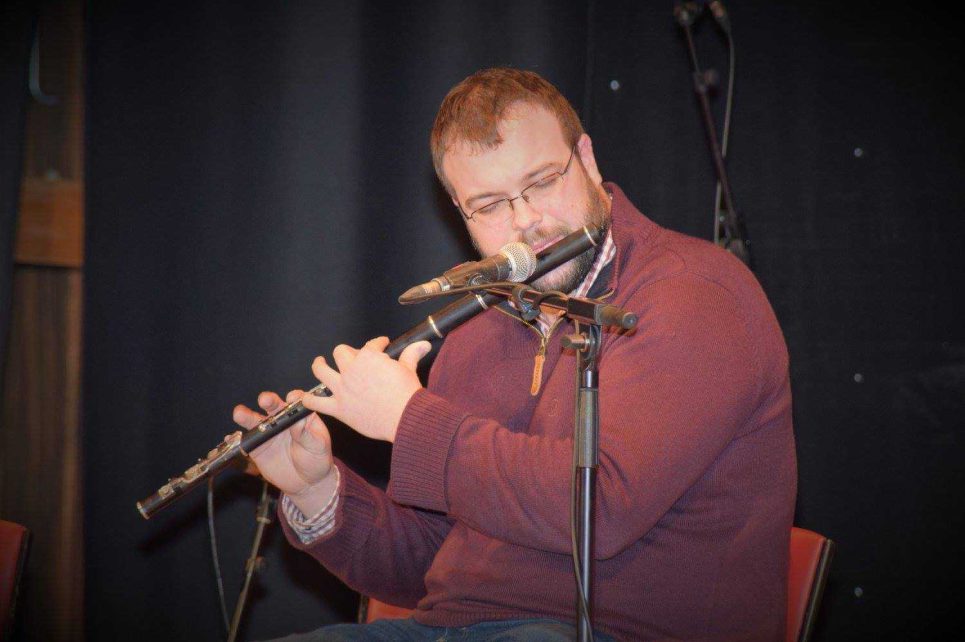 A photograph of Aidan Shannon playing the flute A photograph of Aidan Shannon playing the flute