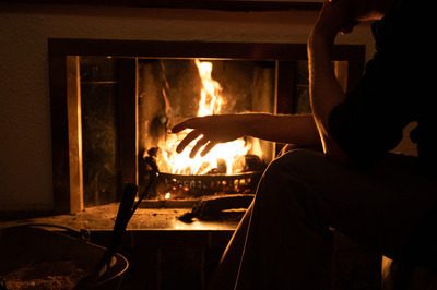 Man warming his hands by a fire